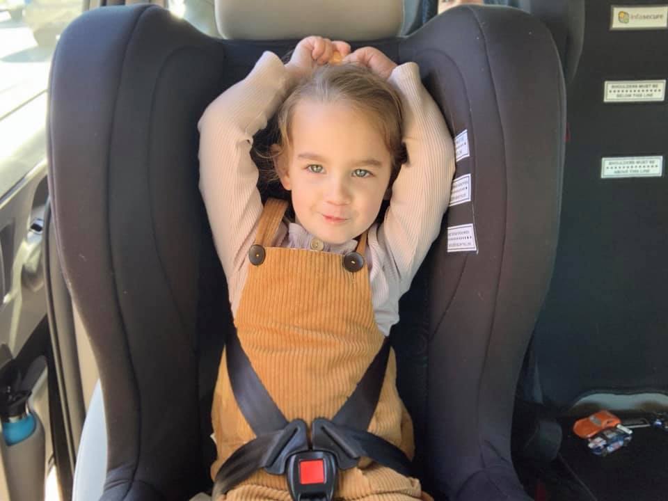 Child escaping car seat harness